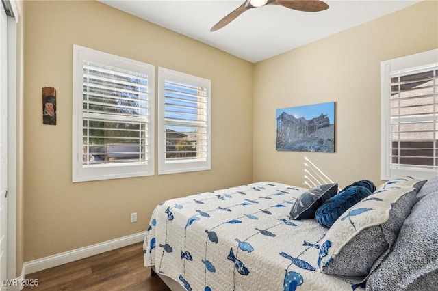 bedroom with ceiling fan and dark hardwood / wood-style flooring