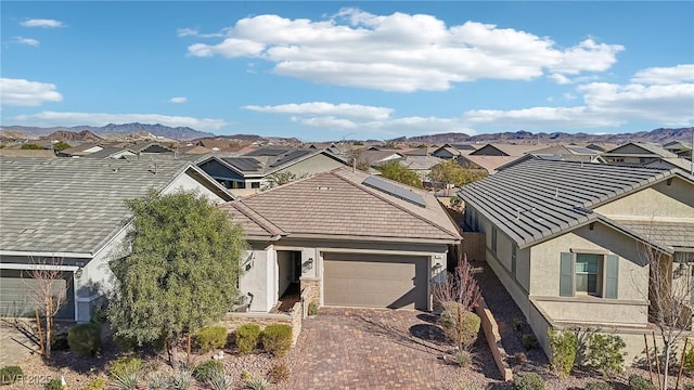 view of front facade featuring a mountain view and a garage