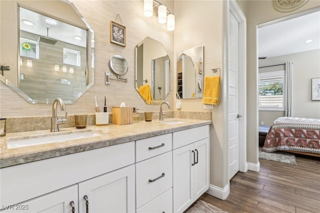 bathroom featuring vanity, wood-type flooring, and a shower