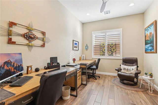 home office with light hardwood / wood-style floors