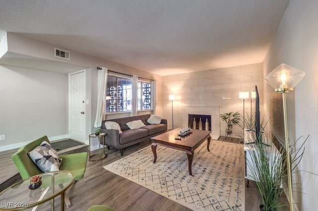 living room with hardwood / wood-style flooring and a textured ceiling