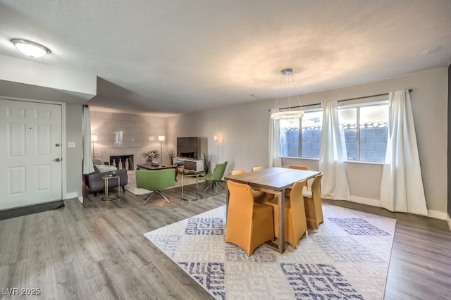 dining room featuring a textured ceiling and light hardwood / wood-style flooring