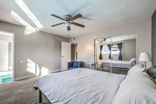 carpeted bedroom with a closet, ceiling fan, and a textured ceiling