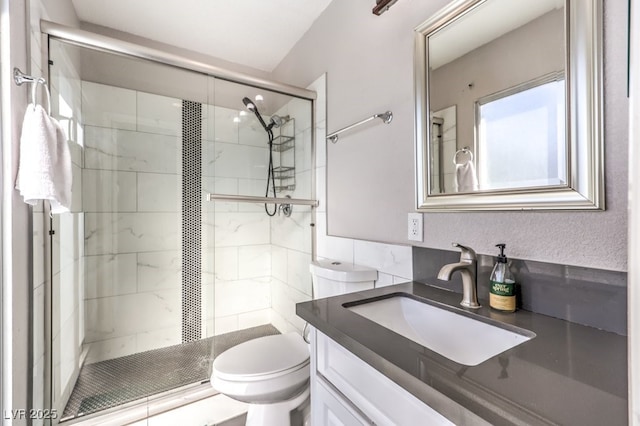 bathroom with vanity, an enclosed shower, and toilet