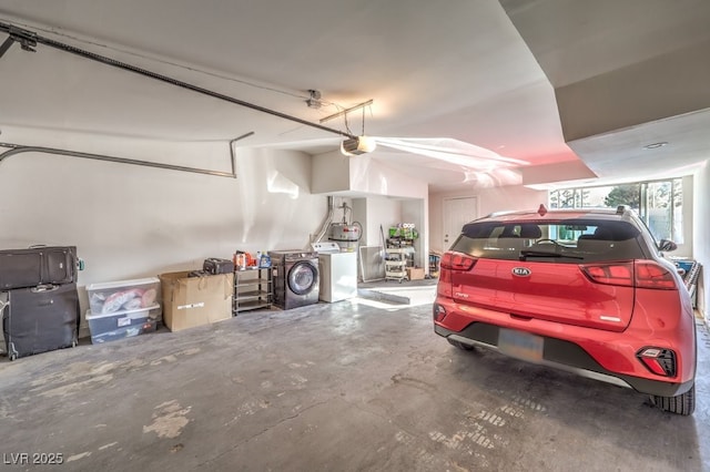 garage with a garage door opener and washer and clothes dryer