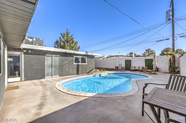 view of pool with cooling unit and a patio area