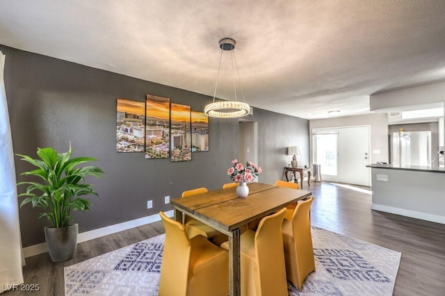 dining area with dark hardwood / wood-style flooring and a textured ceiling