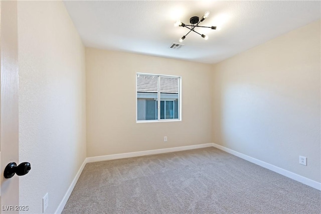 spare room featuring light colored carpet