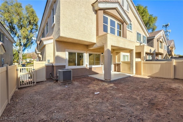 rear view of property featuring a patio area and central AC unit