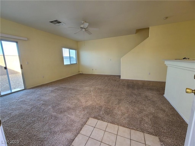 unfurnished living room with ceiling fan and light colored carpet