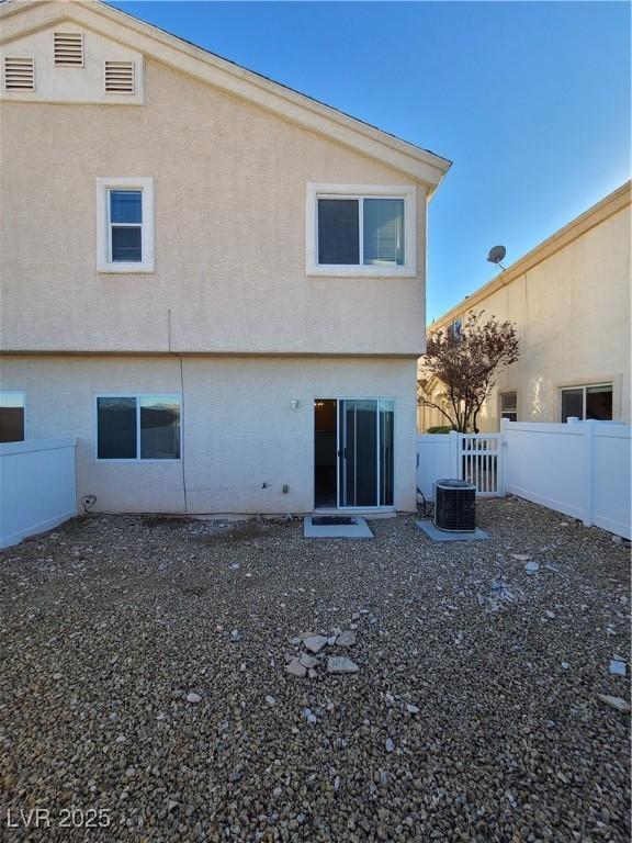 rear view of property with central air condition unit