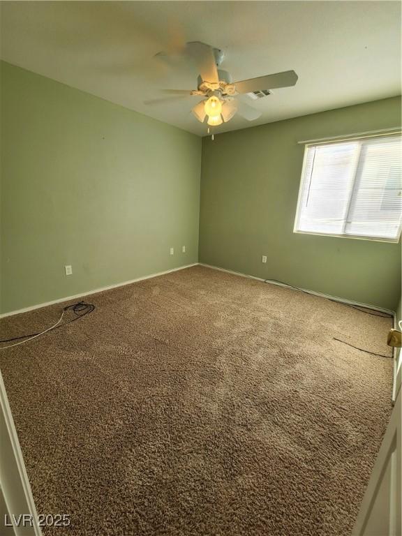 spare room with carpet and ceiling fan