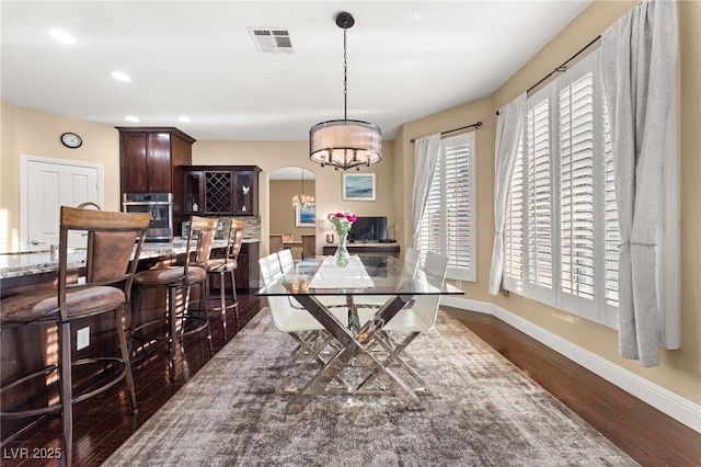 dining space featuring dark hardwood / wood-style floors