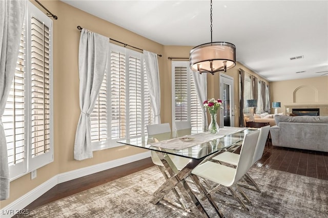 dining space featuring dark wood-type flooring