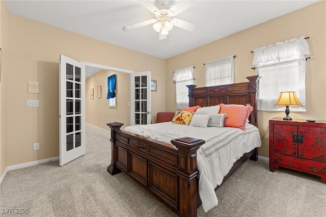 bedroom featuring light colored carpet, ceiling fan, and french doors