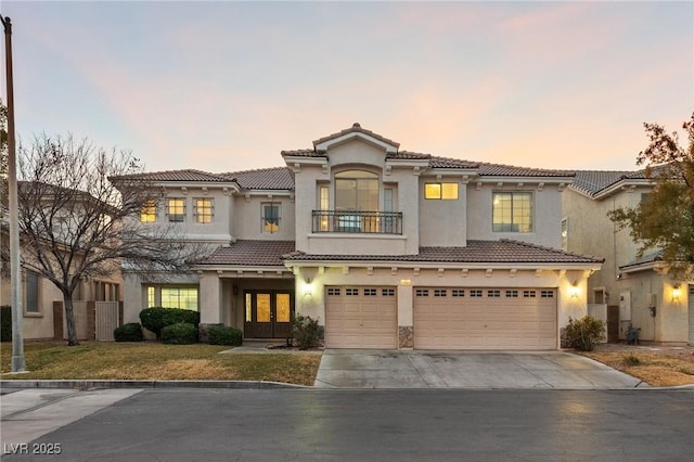 mediterranean / spanish home with a garage and a balcony