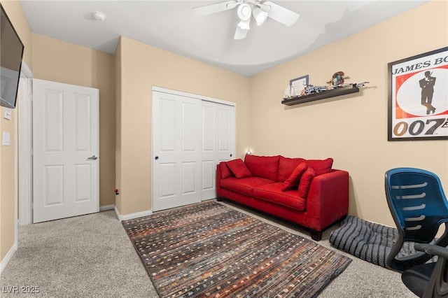 carpeted living room with ceiling fan