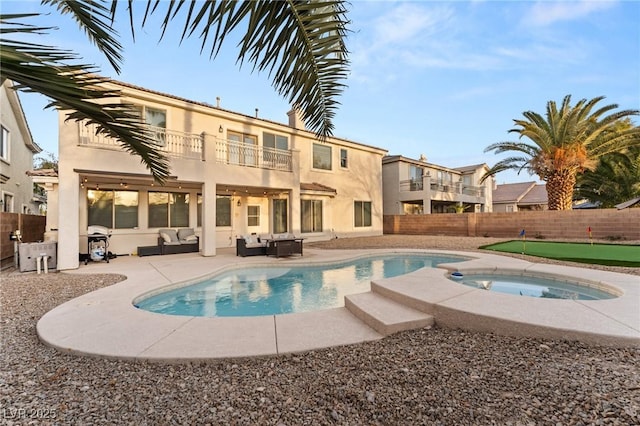 view of swimming pool featuring area for grilling, an outdoor living space, a patio, and an in ground hot tub