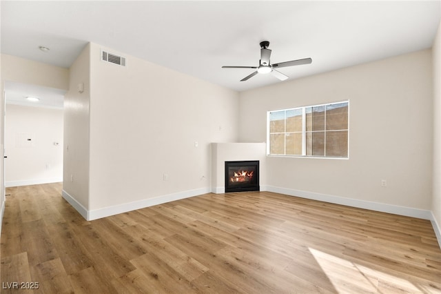 unfurnished living room with ceiling fan and light hardwood / wood-style flooring