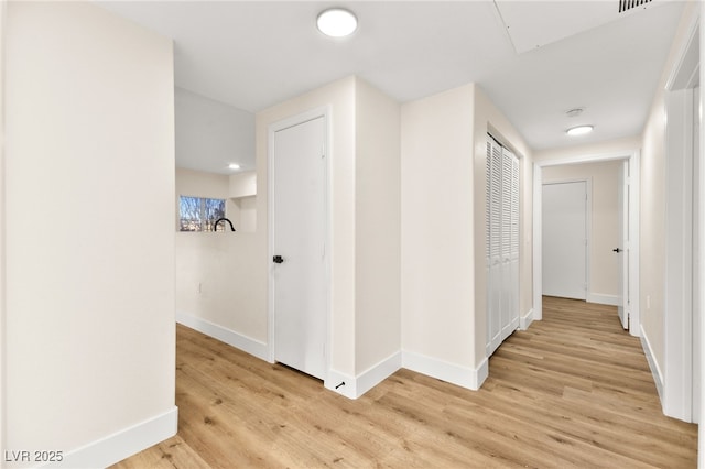 hall with light hardwood / wood-style floors