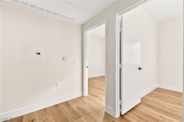 hall featuring wood-type flooring and electric panel