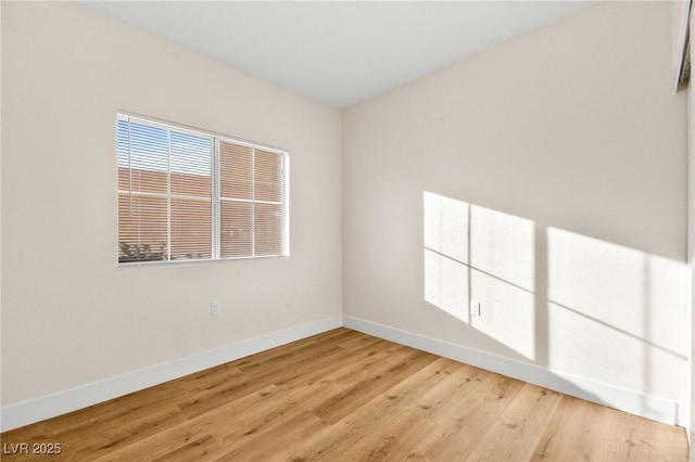 unfurnished room with light wood-type flooring