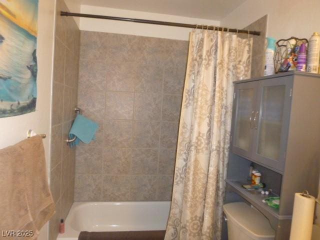 bathroom with shower / bathtub combination with curtain and toilet