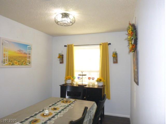 dining room with a textured ceiling