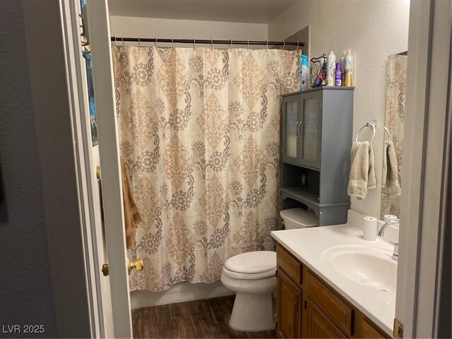 bathroom with hardwood / wood-style flooring, vanity, toilet, and a shower with curtain