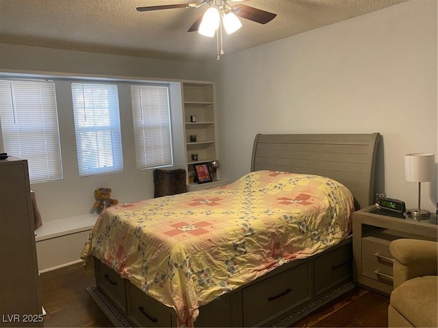 bedroom with dark hardwood / wood-style flooring, ceiling fan, and a textured ceiling