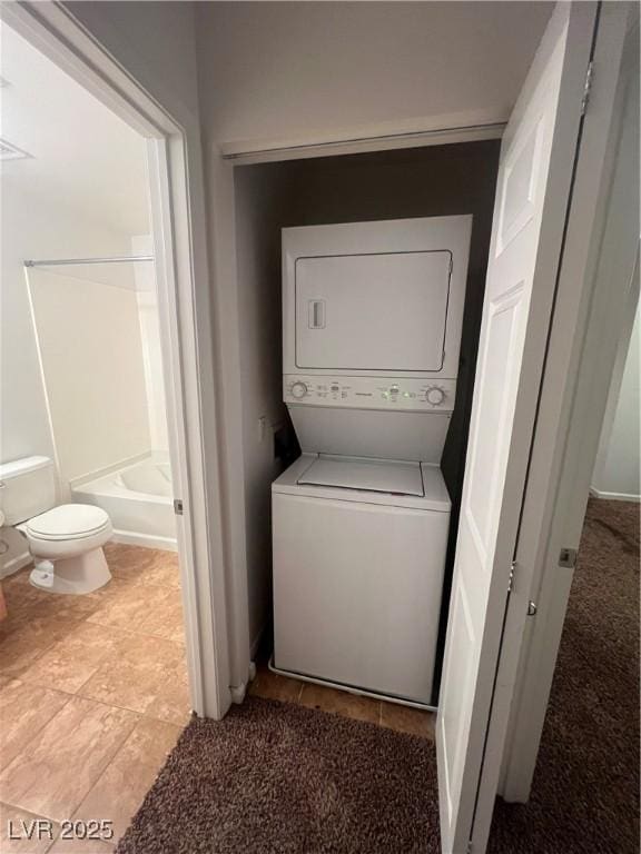 washroom with stacked washer and dryer