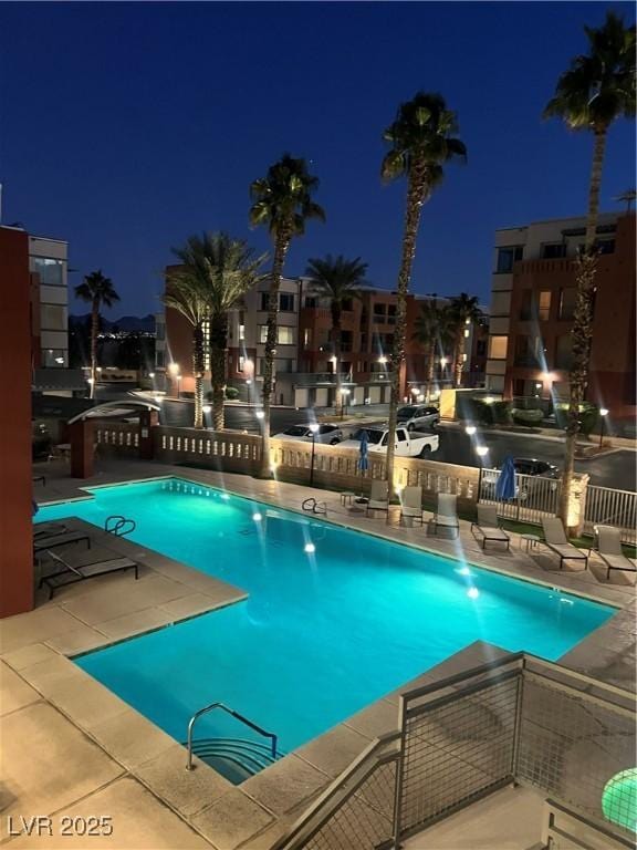 pool at night with a patio