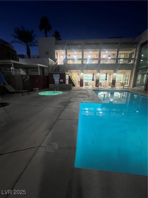 view of pool at twilight