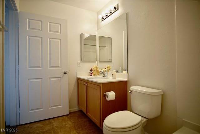 bathroom featuring vanity, tile patterned flooring, and toilet