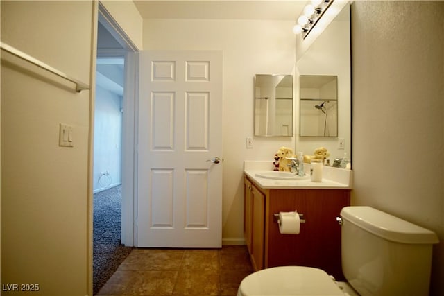 bathroom with vanity, tile patterned floors, and toilet