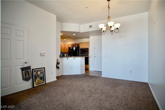 kitchen featuring black refrigerator, a kitchen breakfast bar, wall oven, built in microwave, and dark carpet