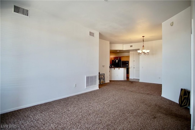 unfurnished living room with carpet and a notable chandelier