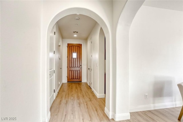 corridor with light hardwood / wood-style flooring