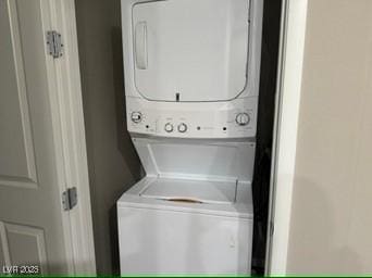 laundry room featuring stacked washing maching and dryer