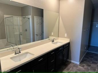 bathroom featuring vanity and an enclosed shower