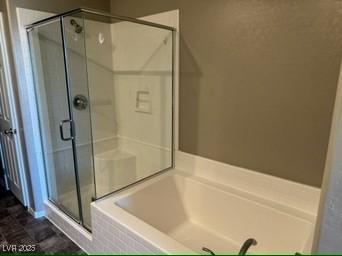 bathroom featuring separate shower and tub