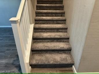 staircase featuring wood-type flooring