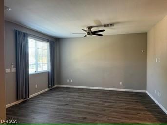 empty room featuring ceiling fan and dark hardwood / wood-style floors