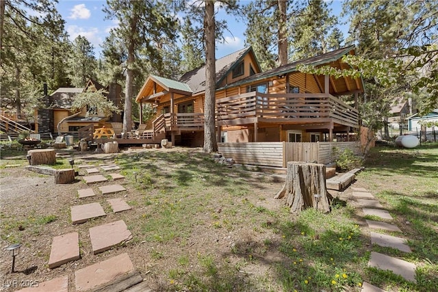 rear view of property featuring a deck