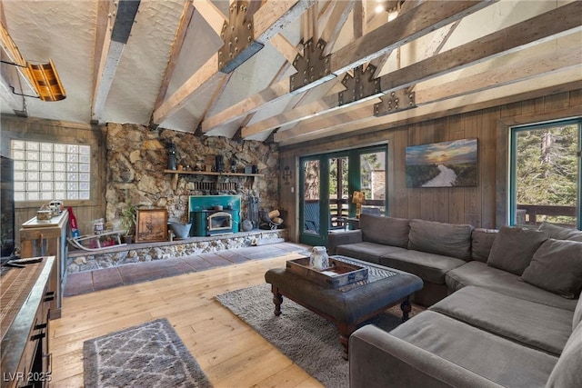 living room featuring a wood stove, hardwood / wood-style floors, and plenty of natural light