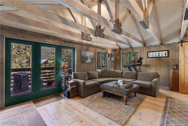 living room featuring wood-type flooring, lofted ceiling with beams, and wooden walls