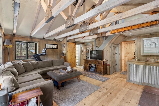 living room featuring lofted ceiling with beams and wooden walls