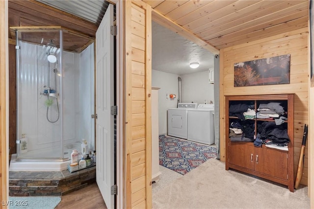 laundry room with separate washer and dryer and light carpet