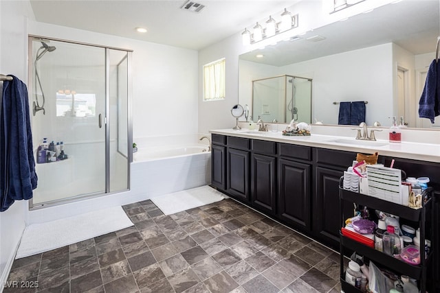 bathroom with vanity and shower with separate bathtub