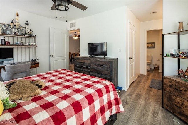 bedroom featuring ceiling fan, hardwood / wood-style flooring, and ensuite bath